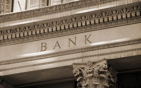 Photo of old bank building with columns.