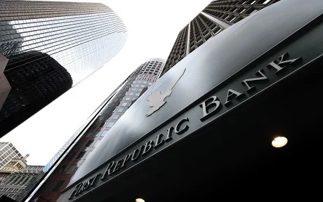 decorative image: first republic bank building photographed from the ground looking up toward the sky with a few tall buildings next to it.
