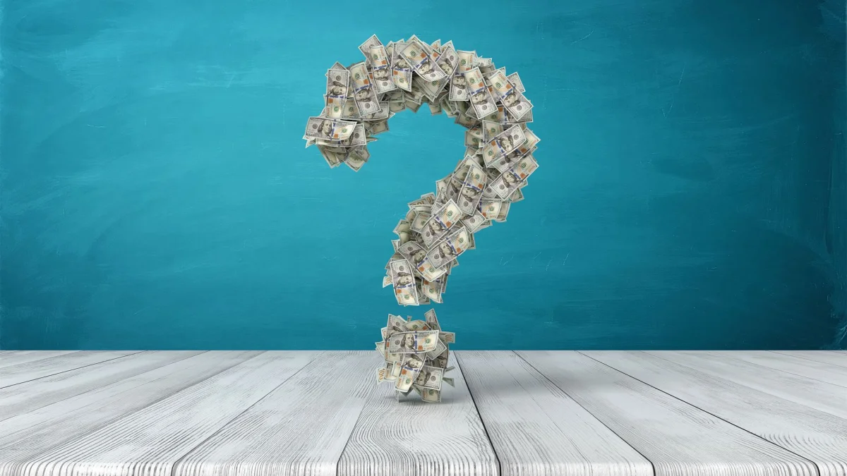 Creative display of a question mark made from money.